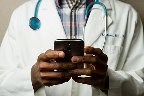 photo of doctor/nurse communicating via cell phone
